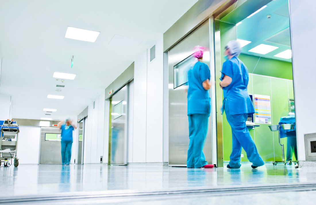 NHS hospital hallway with staff wearing PPE